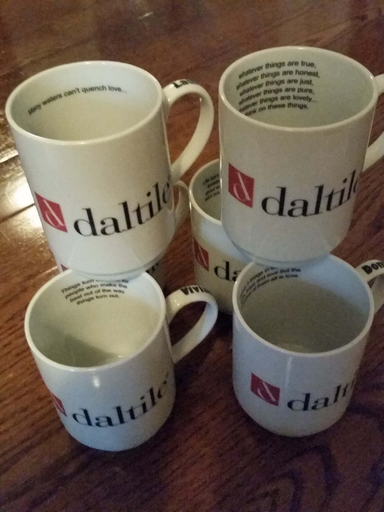 Custom porcelain mugs printed for Daltile with logo branding, inside text, and personalized names on the handles